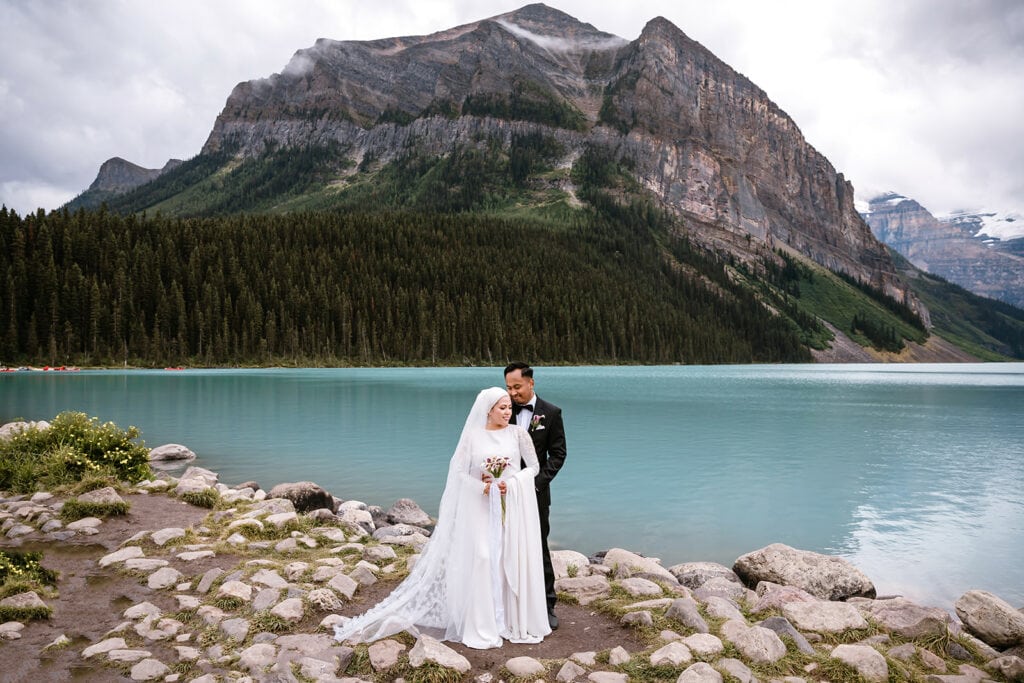 Bride and groom on their elopement in front of Lake Louise.