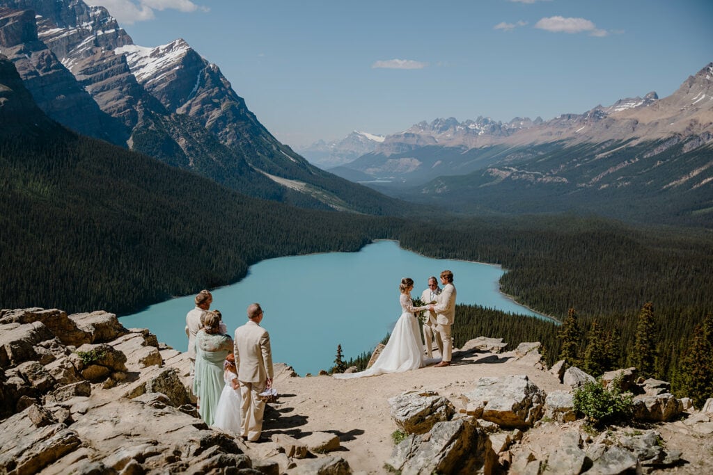 Small wedding in front of Peyto Lake, a blue colour lake in Banff National Park.