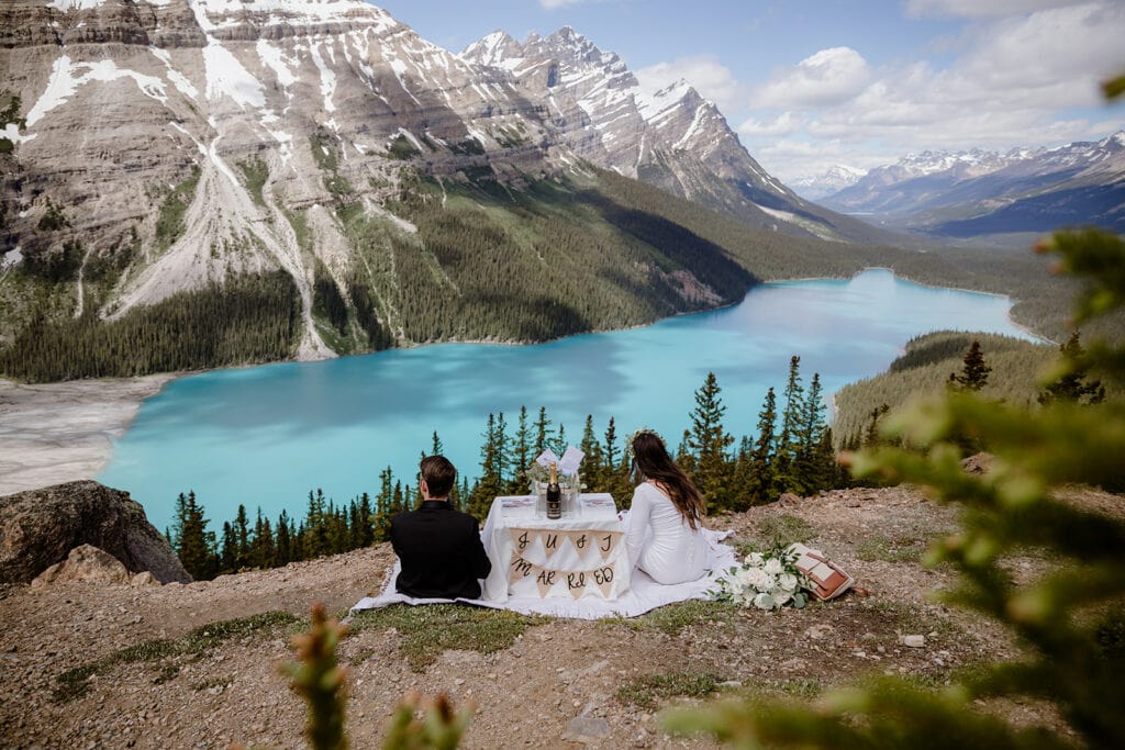 Couples having a picnic on their wedding day in front of Peyto Lake.