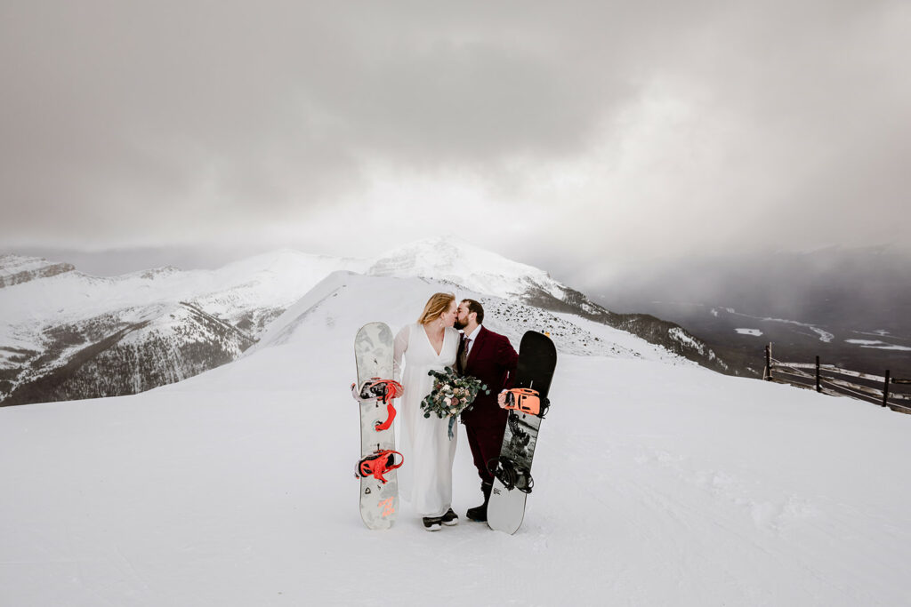 Bride and groom snowboading at Lake Louise Ski Resort on their elopement and wedding day.