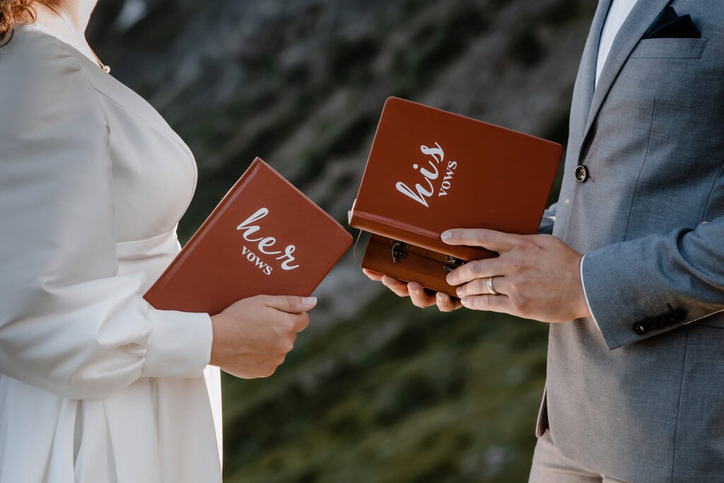 Couple reading their vows after they planned their Banff helicopter elopement 