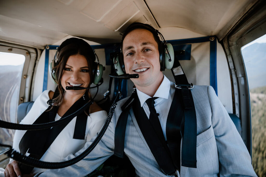 Couples inside of a helicopter smiling and happy on their wedding day 