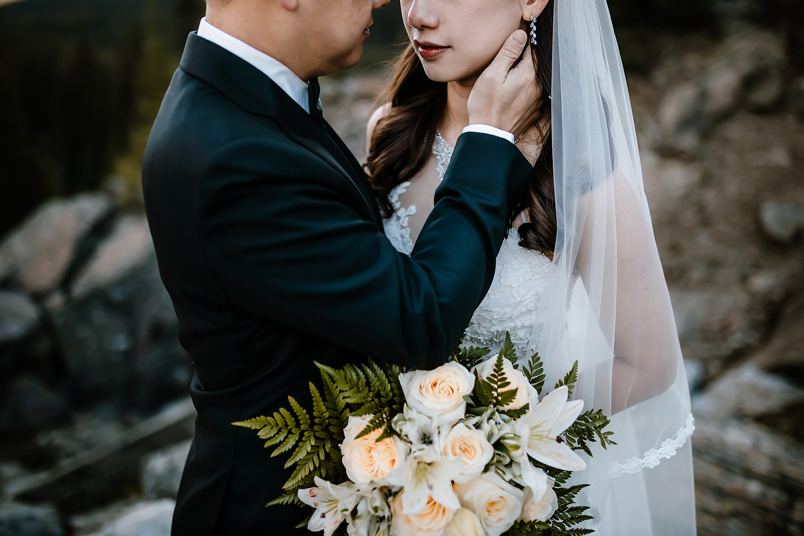 groom holding his bride close during their pre-wedding canoe ride photoshoot at Moraine Lake 