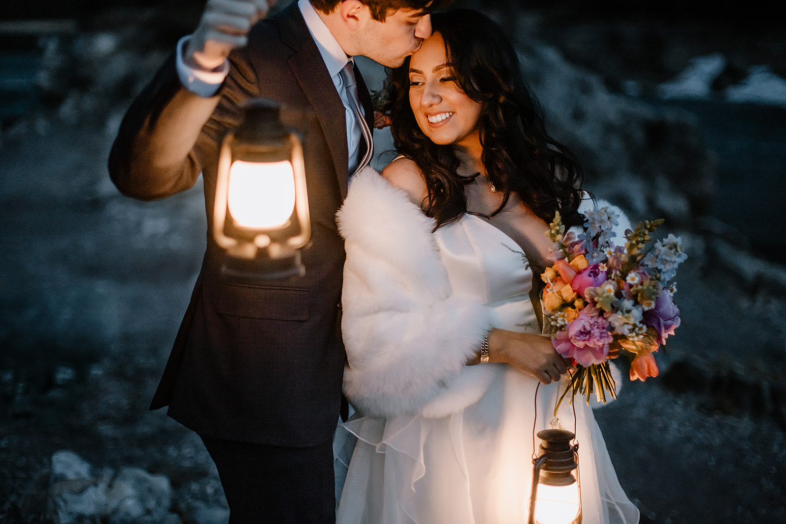 get-married-in-Banff bride and groom holding lanterns during their winter mountain wedding